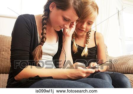 Two girls using smartphone View Large Photo Image Stock Image - Two girls using smartphone. Fotosearch