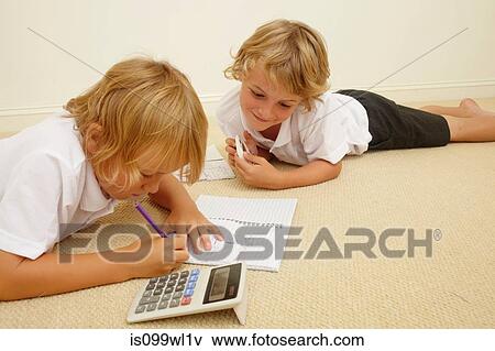 Two schoolboys doing homework View Large Photo Image Stock Photo - Two schoolboys doing homework. Fotosearch