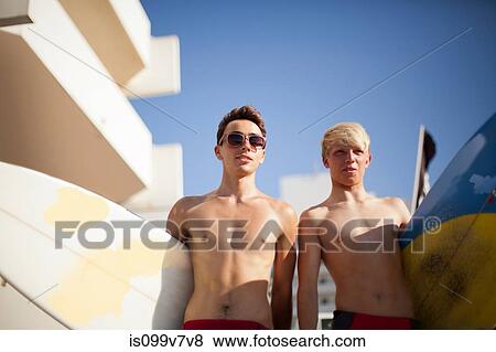 Two young men heading to the beach with surfboards View Large Photo Image Stock Photo - Two young men heading to the beach with surfboards. Fotosearch