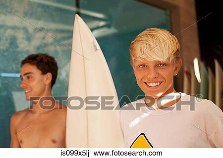 Two young men with surfboard View Large Photo Image Stock Image - Two young men with surfboard. Fotosearch