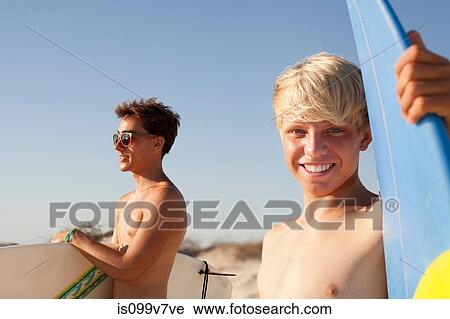 Two young men with surfboards View Large Photo Image Stock Image - Two young men with surfboards. Fotosearch