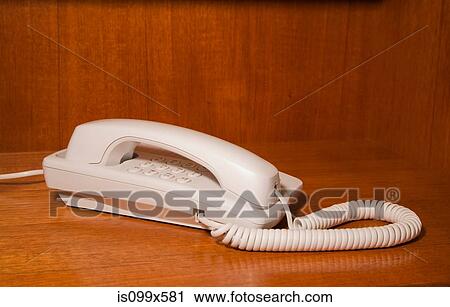Stock Image - White landline telephone. Fotosearch