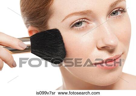 Woman applying blusher with brush View Large Photo Image Stock Photography - Woman applying blusher with brush. Fotosearch