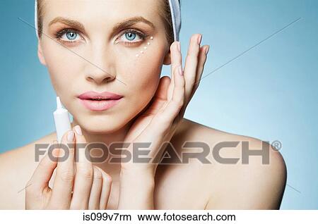 Woman applying eye cream View Large Photo Image Picture - Woman applying eye cream. Fotosearch