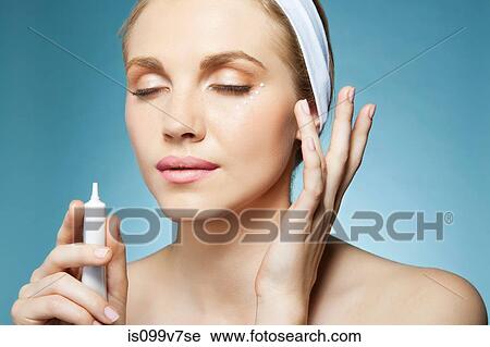 Woman applying eye cream View Large Photo Image Stock Image - Woman applying eye cream. Fotosearch