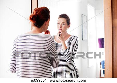 Woman applying make up View Large Photo Image Stock Image - Woman applying make up. Fotosearch