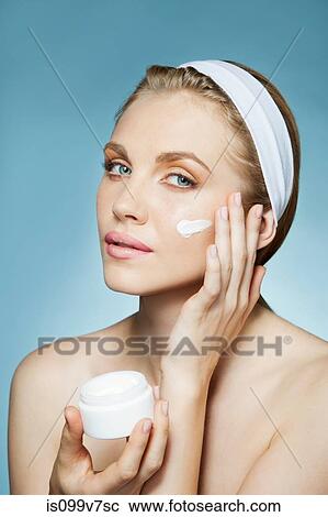 Woman applying moisturiser View Large Photo Image Stock Image - Woman applying moisturiser. Fotosearch