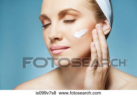 Woman applying moisturiser View Large Photo Image Stock Photo - Woman applying moisturiser. Fotosearch