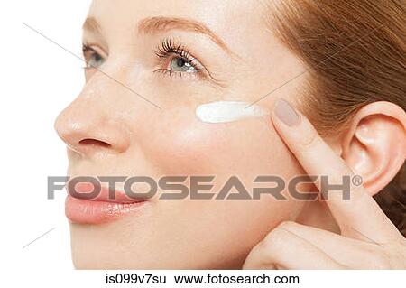 Woman applying moisturiser View Large Photo Image Stock Photograph - Woman applying moisturiser. Fotosearch