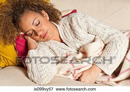 Stock Photo - Woman asleep on sofa. Fotosearch