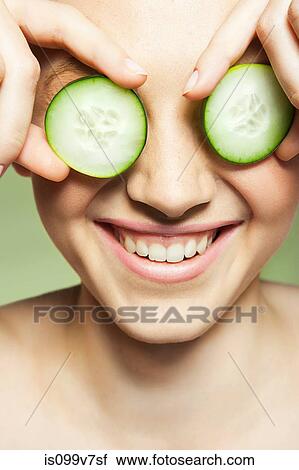 Woman covering eyes with cucumber View Large Photo Image Stock Image - Woman covering eyes with cucumber. Fotosearch