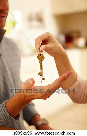 Stock Photograph - Woman giving man house key. Fotosearch