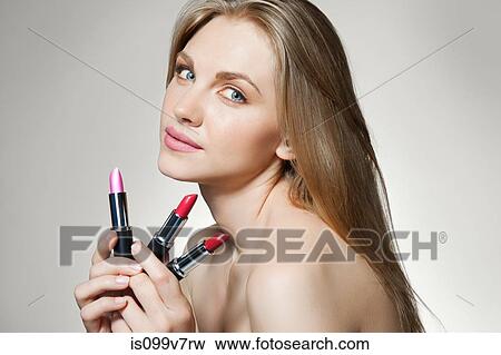Woman holding lipsticks View Large Photo Image Stock Photo - Woman holding lipsticks. Fotosearch