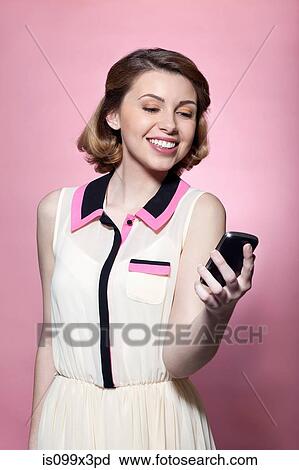 Woman holding smartphone View Large Photo Image Stock Image - Woman holding smartphone. Fotosearch