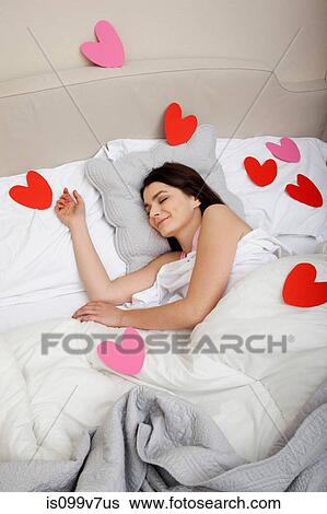Woman in bed with heart shapes on bedclothes View Large Photo Image Stock Photograph - Woman in bed with heart shapes on bedclothes. Fotosearch