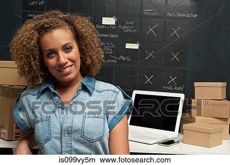 Woman in home office with cardboard boxes View Large Photo Image Picture - Woman in home office with cardboard boxes. Fotosearch