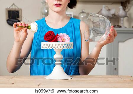 Woman lifting lid of cake stand with flowers View Large Photo Image Stock Photograph - Woman lifting lid of cake stand with flowers. Fotosearch