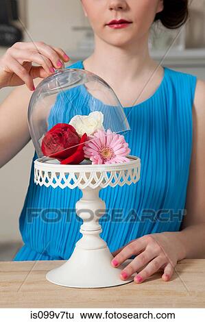 Woman lifting lid of cake stand with flowers View Large Photo Image Stock Photograph - Woman lifting lid of cake stand with flowers. Fotosearch