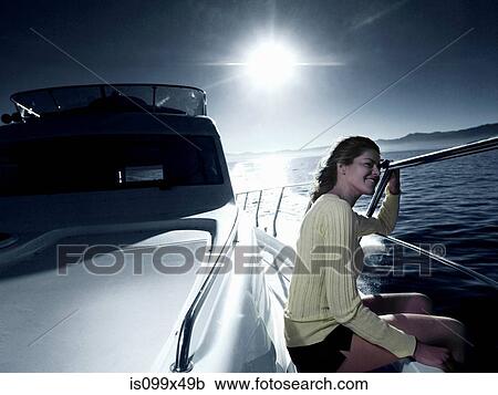 Stock Image - Woman on deck of yacht. Fotosearch