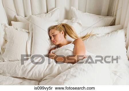 Stock Photography - Woman sleeping in bed. Fotosearch