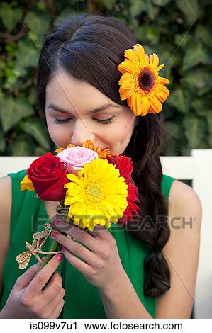 Woman smelling flowers View Large Photo Image Stock Image - Woman smelling flowers. Fotosearch