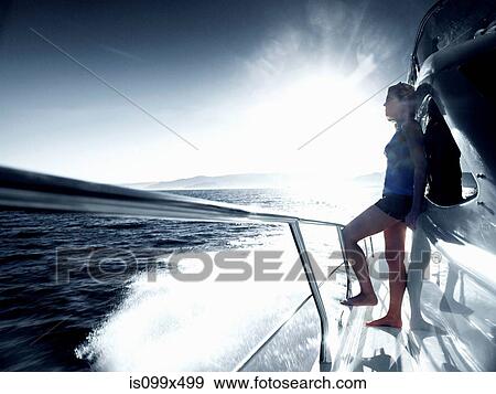 Woman standing alone on deck of yacht View Large Photo Image Stock Photo - Woman standing alone on deck of yacht. Fotosearch