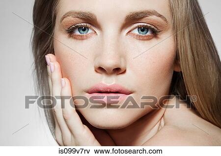 Woman touching cheek View Large Photo Image Stock Photo - Woman touching cheek. Fotosearch