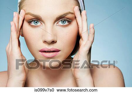 Stock Image - Woman touching face. Fotosearch