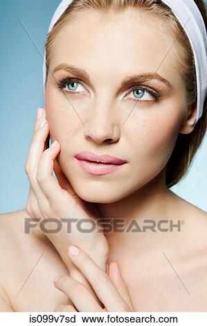 Stock Image - Woman touching face. Fotosearch