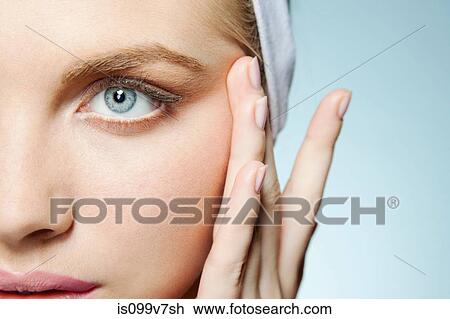 Stock Image - Woman touching face. Fotosearch