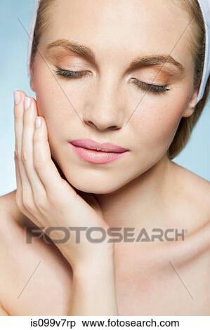 Woman touching face View Large Photo Image Stock Photography - Woman touching face. Fotosearch