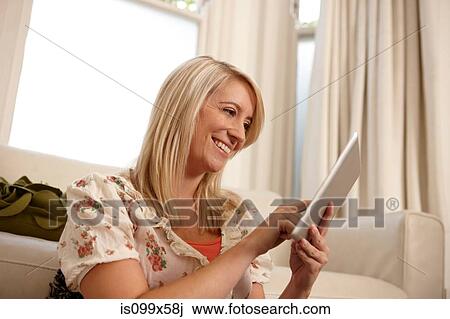 Stock Image - Woman using digital tablet. Fotosearch
