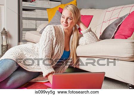 Woman using laptop daydreaming View Large Photo Image Stock Image - Woman using laptop daydreaming. Fotosearch