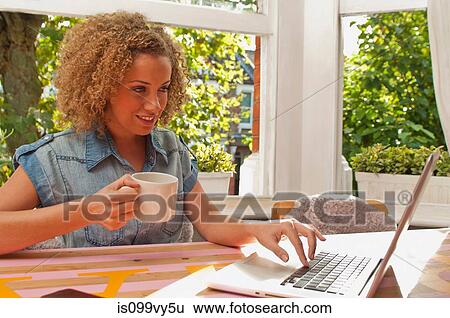 Stock Photograph - Woman using laptop. Fotosearch