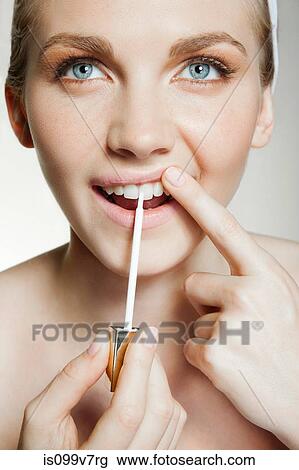 Woman using tooth whitening brush View Large Photo Image Stock Image - Woman using tooth whitening brush. Fotosearch