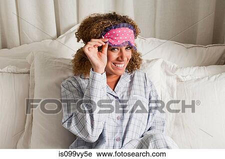 Woman wearing eye mask in bed View Large Photo Image Stock Image - Woman wearing eye mask in bed. Fotosearch