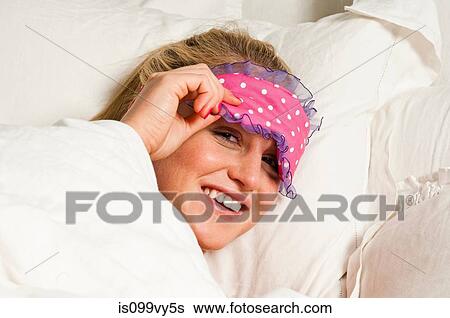 Woman wearing eye mask in bed View Large Photo Image Stock Photograph - Woman wearing eye mask in bed. Fotosearch