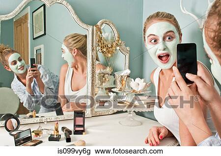 Woman wearing face mask being photographed by friend View Large Photo Image Stock Image - Woman wearing face mask being photographed by friend. Fotosearch