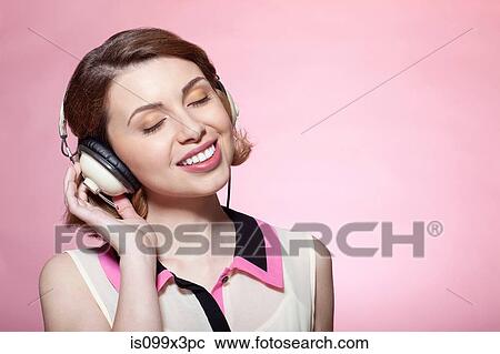 Stock Image - Woman wearing headphones. Fotosearch