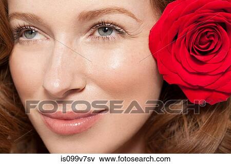 Woman wearing red rose in her hair View Large Photo Image Stock Photo - Woman wearing red rose in her hair. Fotosearch