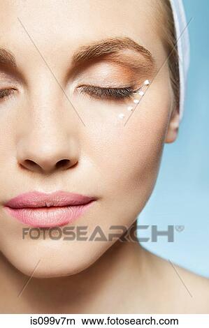 Woman with eye cream around eye View Large Photo Image Picture - Woman with eye cream around eye. Fotosearch