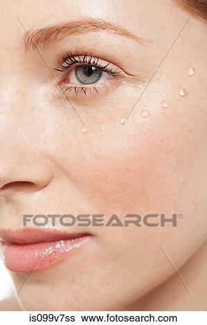 Stock Photograph - Woman with eye gel on her face. Fotosearch