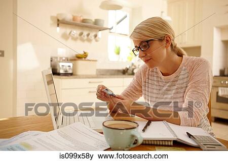 Woman with laptop holding credit card View Large Photo Image Stock Photo - Woman with laptop holding credit card. Fotosearch