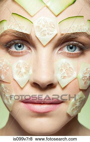 Woman with pieces of cucumber covering face View Large Photo Image Stock Photo - Woman with pieces of cucumber covering face. Fotosearch