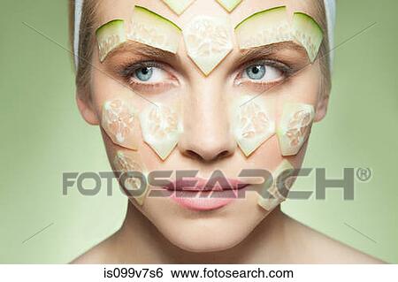 Woman with pieces of cucumber covering face View Large Photo Image Stock Photograph - Woman with pieces of cucumber covering face. Fotosearch