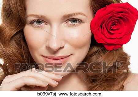 Woman with red rose in her hair View Large Photo Image Stock Image - Woman with red rose in her hair. Fotosearch
