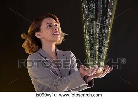 Stock Photograph - Woman with virtual technological information in her hands. Fotosearch