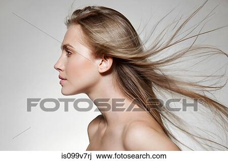 Stock Image - Woman with windswept long hair. Fotosearch