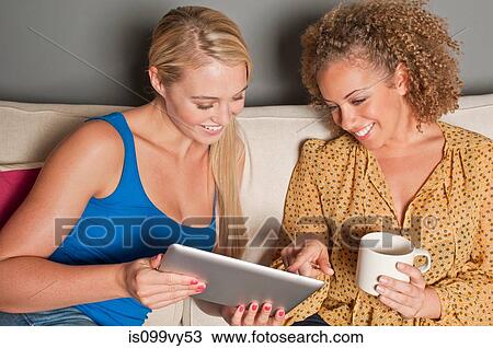 Stock Image - Women with digital tablet. Fotosearch