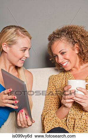 Stock Image - Women with digital tablet. Fotosearch